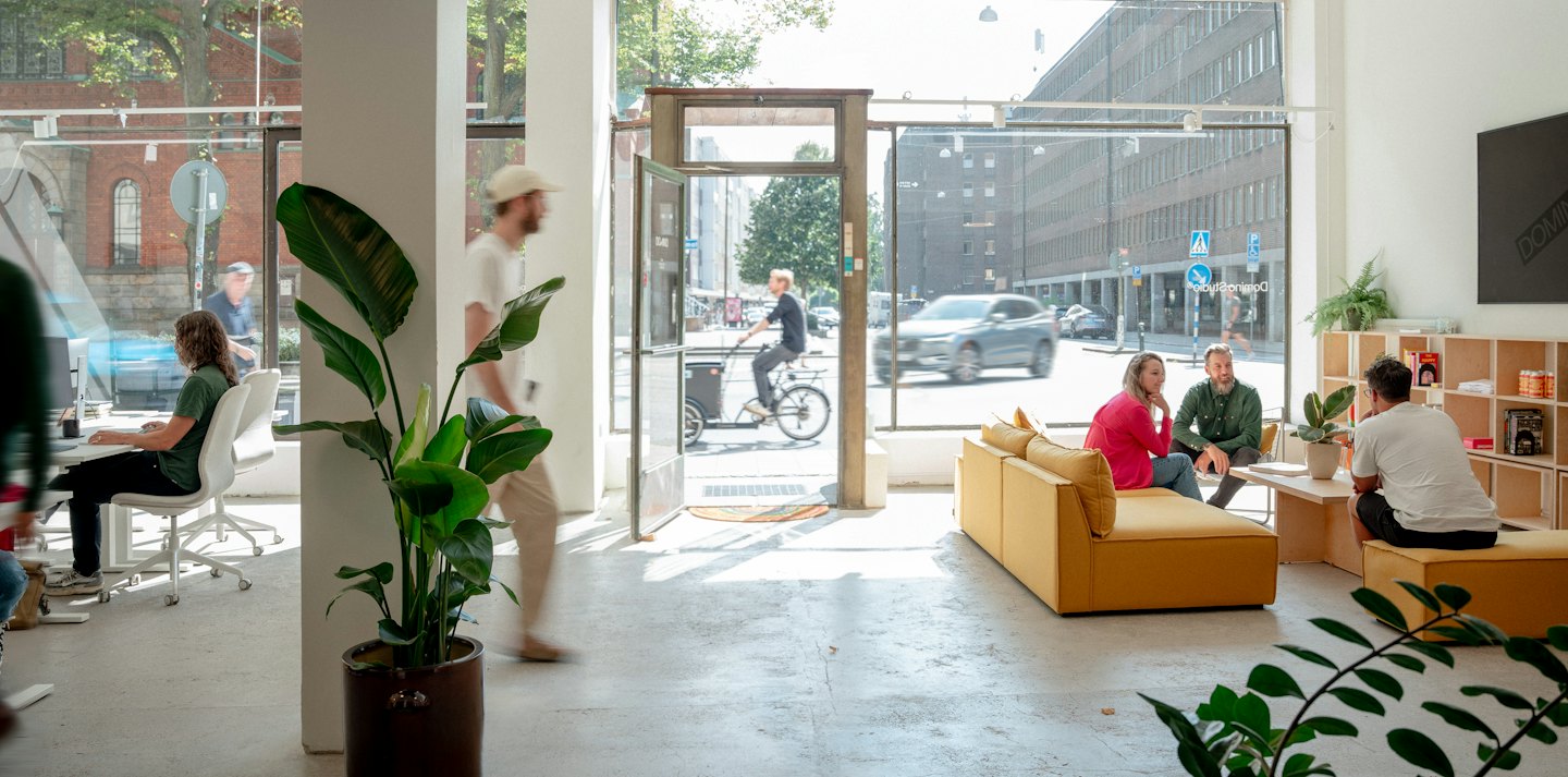 Open-plan office with people working and socializing.